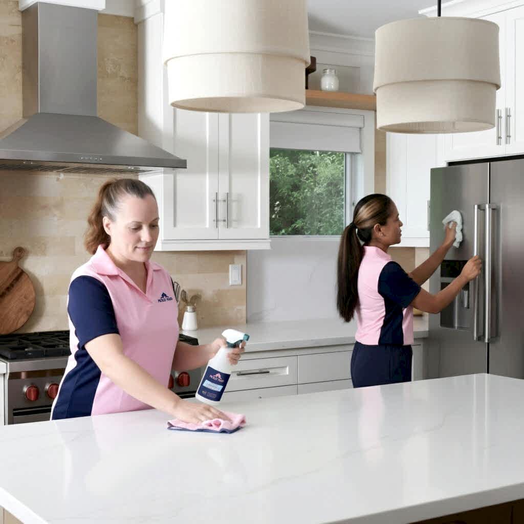 Two MOLLY MAID professionals providing professional home cleaning services while homeowners enjoy free time